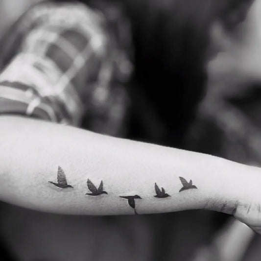 Small Fine Line Flock of Birds Tattoo on Women Arm by @mukul_tattooz