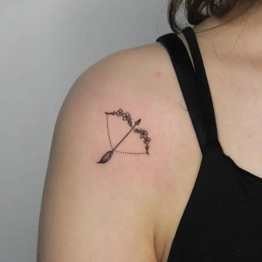 Small Fine Line Floral Arrow Tattoo on Women Shoulder by @onurzeytin.ink