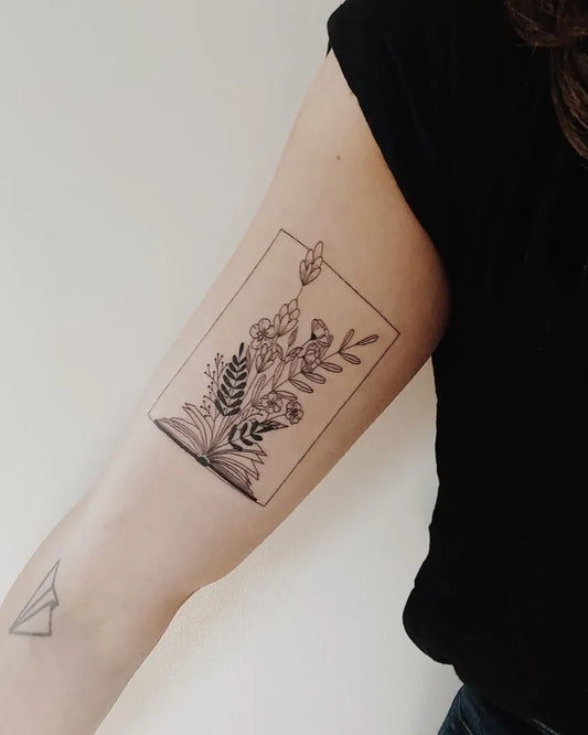 Small Fine Line Floral Bouquet Tattoo on Women Bicep by @saltandinknz
