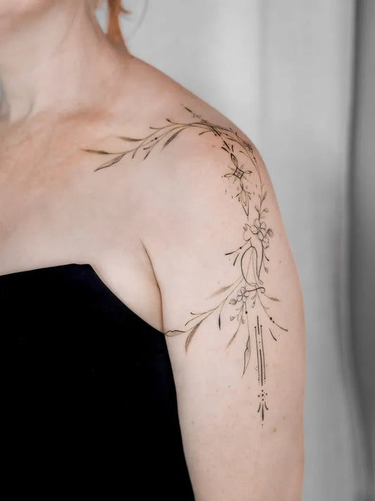 Small Fine Line Floral Branch Tattoo on Women Shoulder by @the_moderndayhippie_tattoo