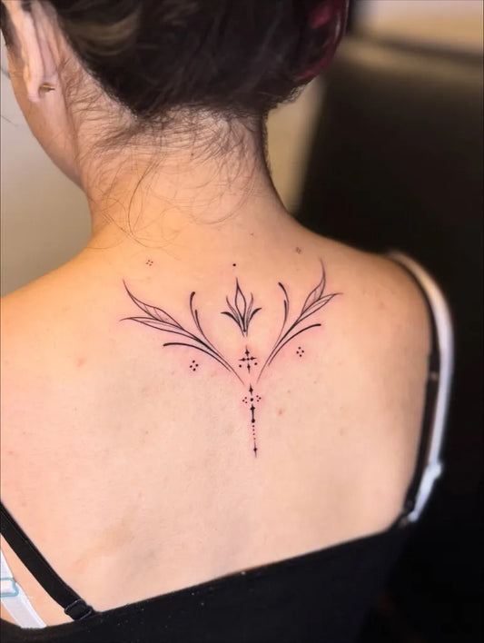 Small Fine Line Floral Cross on Women Spine Tattoo by @pigmentedtattoos