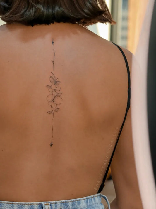Small Fine Line Floral Vine on Women Back Tattoo by @mariafernanda.ink