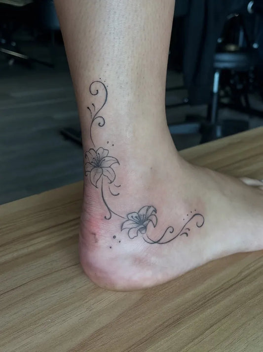 Small Fine Line Floral Vines Tattoo on Women Ankle by @gianna.tattoos_