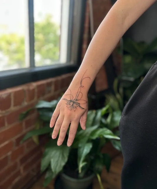 Small Fine Line Floral Vines on Women Wrist Tattoo by @bryonytatz