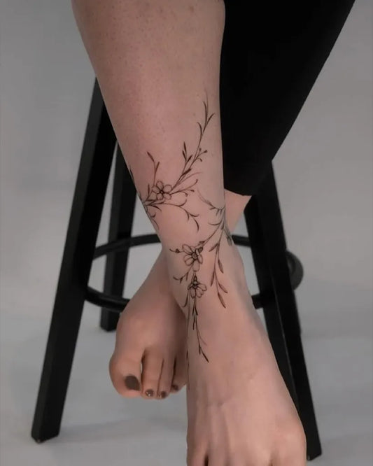 Small Fine Line Flower Branch Tattoo on Women Ankle by @tattoo_magazine_kor