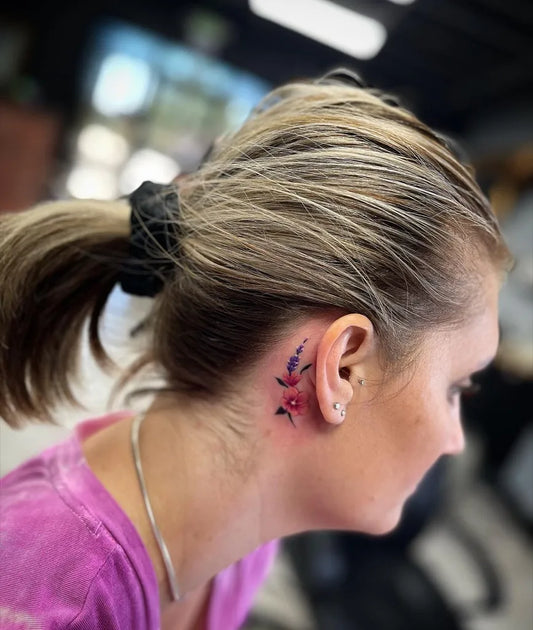 Small Fine Line Flower Tattoo on Women Behind the Ear by @patriciaquinlantattoos