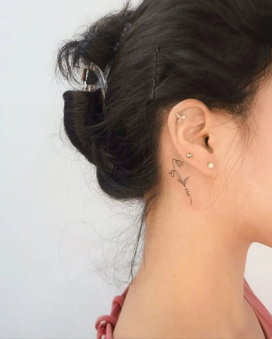 Small Fine Line Flower Tattoo on Women Behind the Ear by @yeowool_tattooer