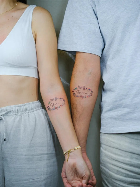 Small Fine Line Flower Wreath Family Tattoo on Women Arm by @yaz.inks