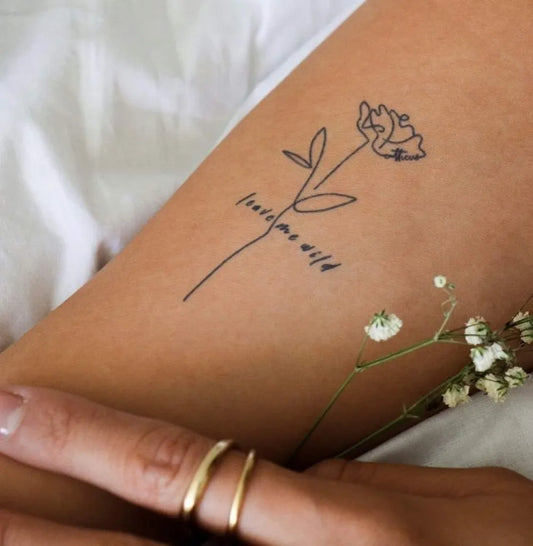 Small Fine Line Flower and Text Tattoo on Women Arm by @atticuspoetry