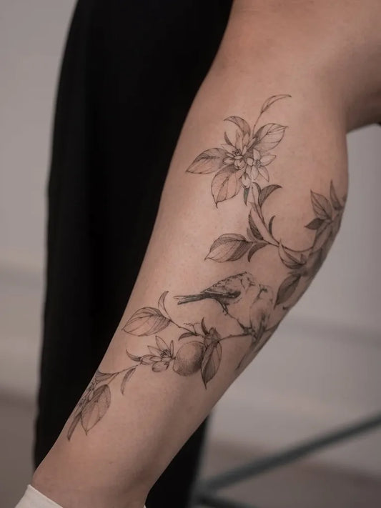 Small Fine Line Flowers Bird on Women Leg Tattoo by @inkgarden