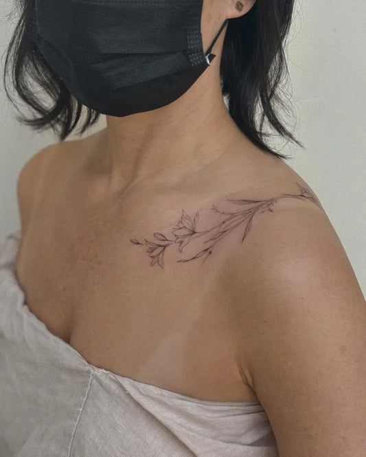Small Fine Line Flowers and Branches Tattoo on Women Collarbone by @narot_6.49oz