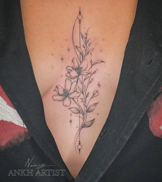 Small Fine Line Flowers and Stars on Women Sternum Tattoo by @ankh.artist
