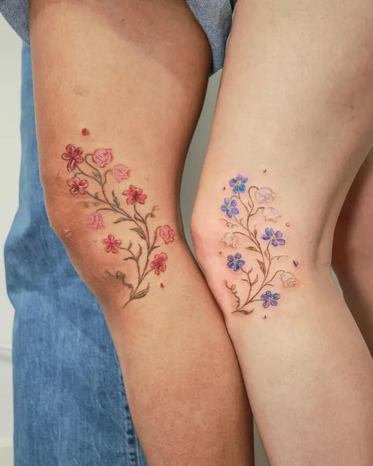 Small Fine Line Flowers on Couple Knees Matching Tattoo by @dahlia_tattooist