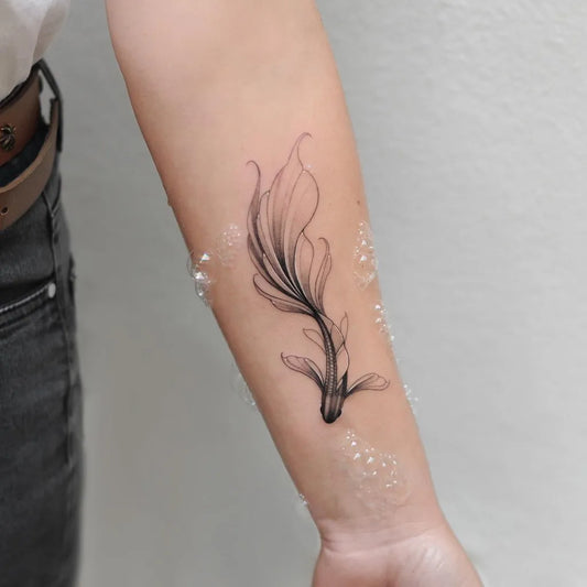 Small Fine Line Flowing Fish Tattoo on Women Arm by @nastyafox