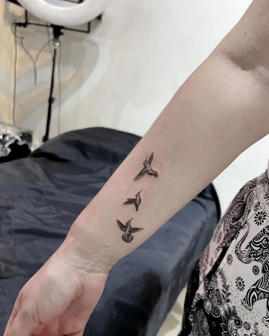 Small Fine Line Flying Birds Tattoo on Women Arm by @happyrain.tatt