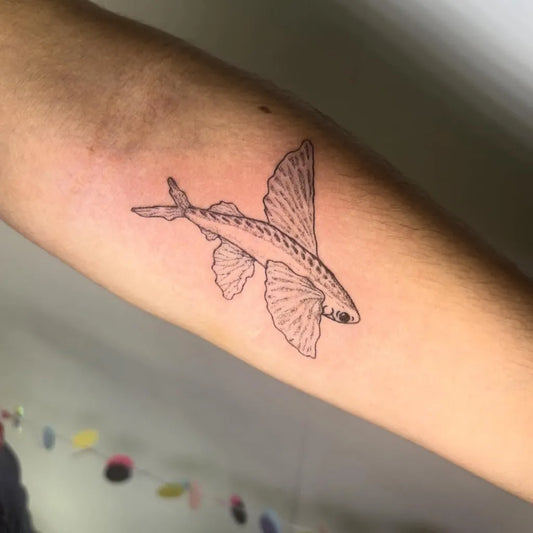 Small Fine Line Flying Fish Tattoo on Women Forearm by @florannan