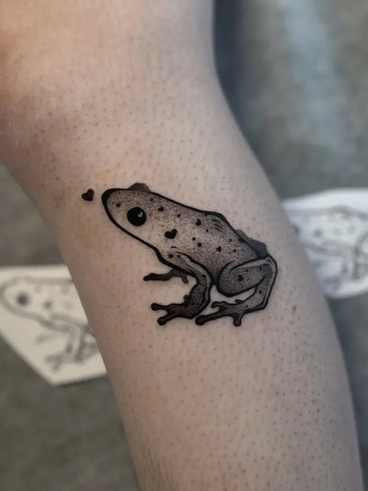 Small Fine Line Frog Tattoo on Women Forearm by @sourfangstattoo