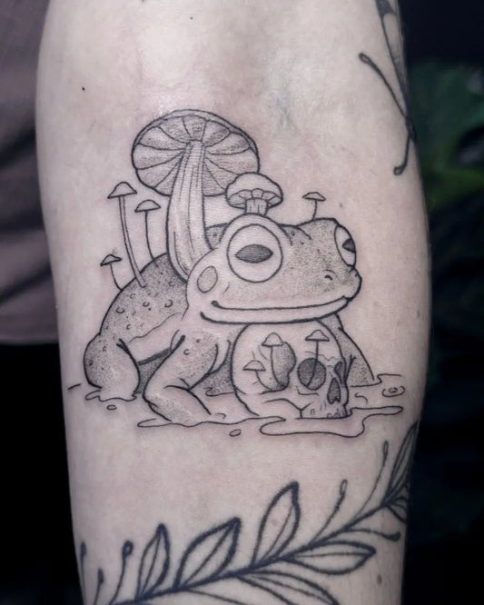 Small Fine Line Frog and Mushrooms Tattoo on Women Arm by @ernieinks