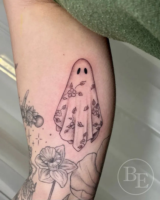 Small Fine Line Ghost with Flowers Tattoo on Women Arm by @brenna.eagan