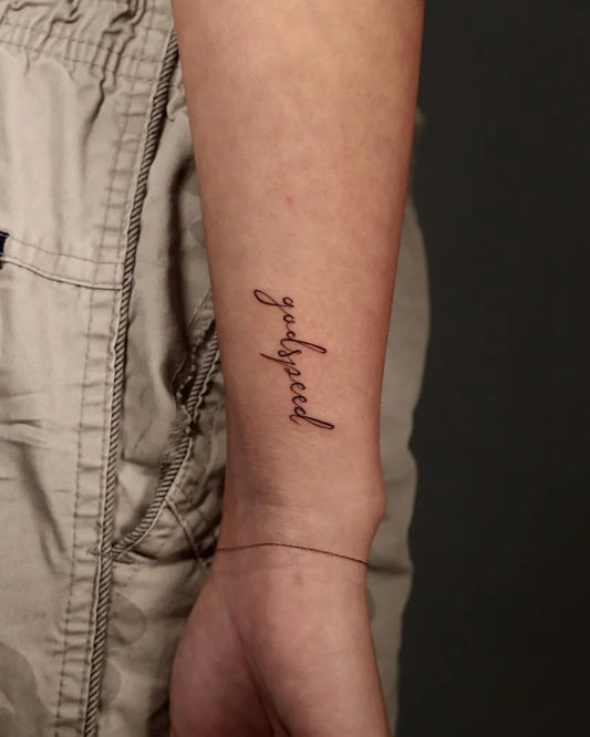 Small Fine Line Godspeed Quote Tattoo on Women Wrist by @artelibregallery.nyc
