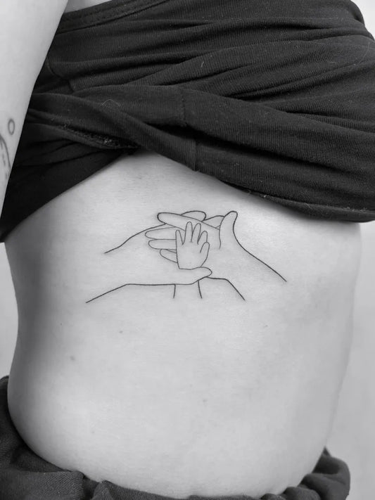 Small Fine Line Hands Family Tattoo on Women Rib by @karina.miko