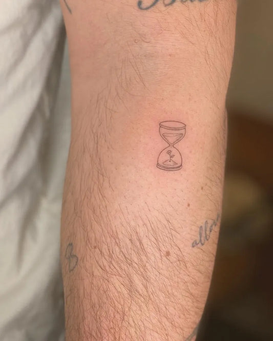 Small Fine Line Hourglass Tattoo on Men Arm by @tattoovasquez