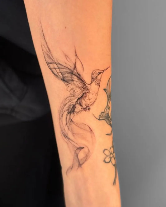 Small Fine Line Hummingbird Flowers on Women Arm Tattoo by @keana.6tattoo