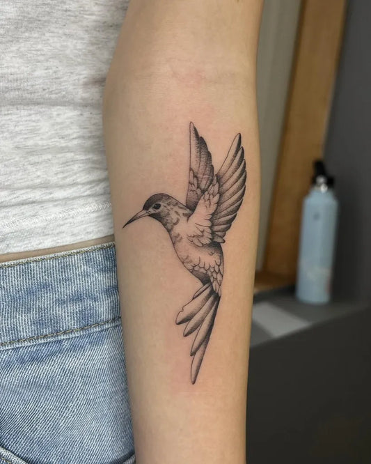 Small Fine Line Hummingbird Tattoo on Women Arm by @harmlesskittytattoo