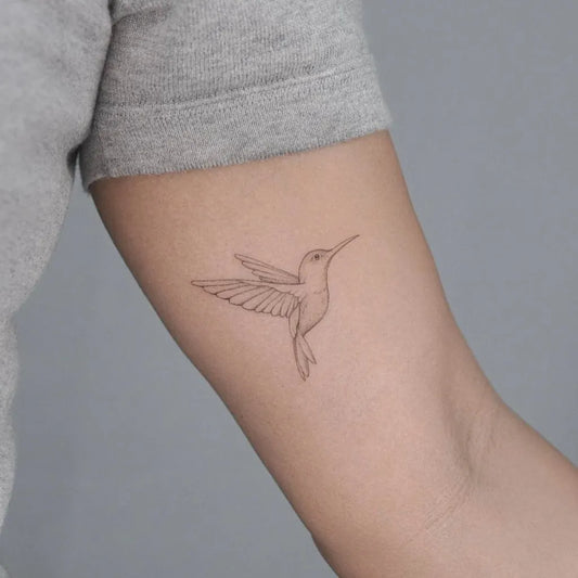 Small Fine Line Hummingbird on Women Upper Arm Tattoo by @puertoink_antwerp