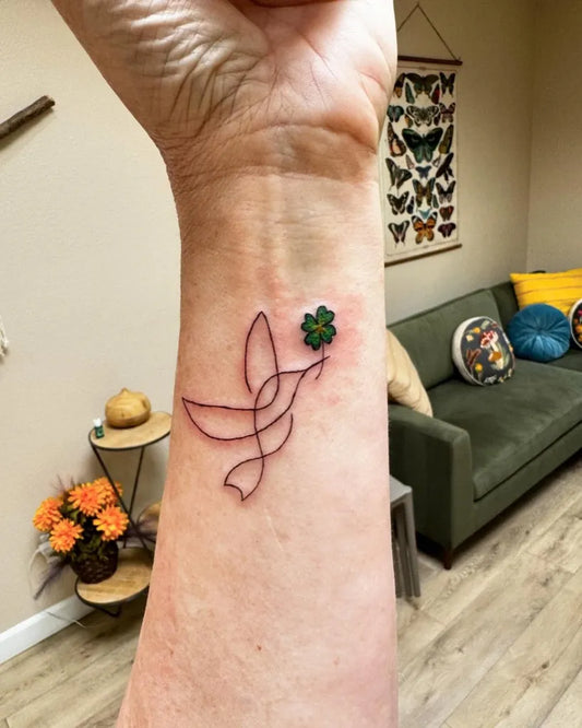 Small Fine Line Hummingbird with Flower on Women Wrist Tattoo by @alienbooger_