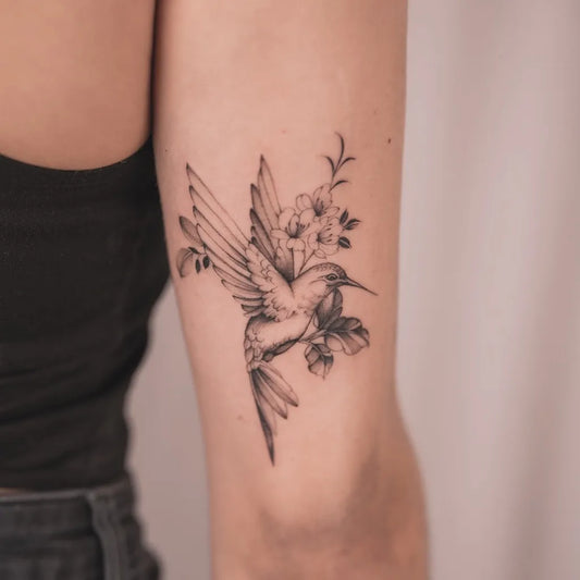 Small Fine Line Hummingbird with Flowers on Women Arm Tattoo by @leo.6tattoo