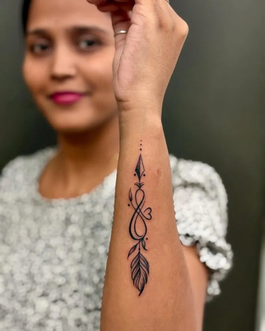 Small Fine Line Infinity Arrow Feather Tattoo on Women Wrist by @skinmachinetattoo