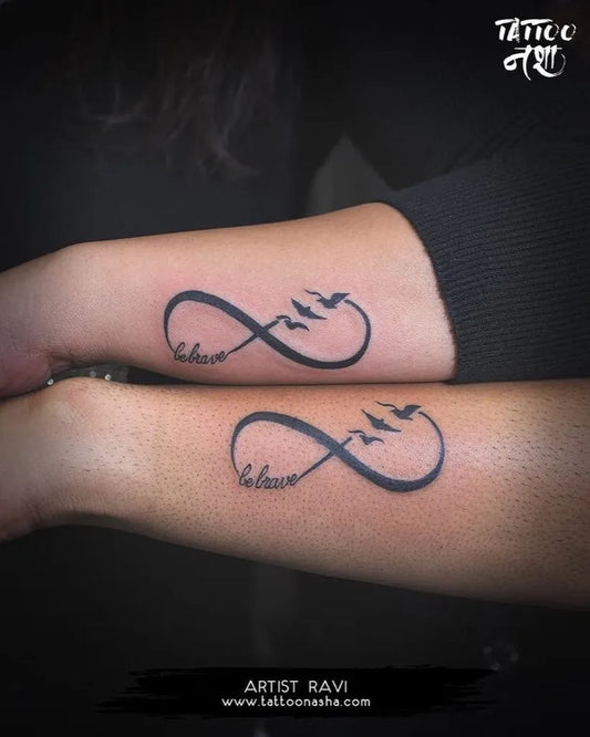 Small Fine Line Infinity Birds Tattoo on Women Arm by @ravi_tattooist__