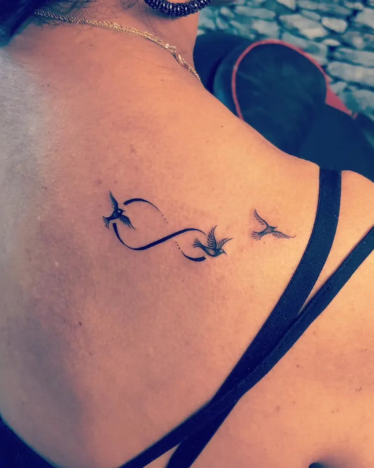Small Fine Line Infinity Birds Tattoo on Women Shoulder by @rupesh_ryaps_tattooist