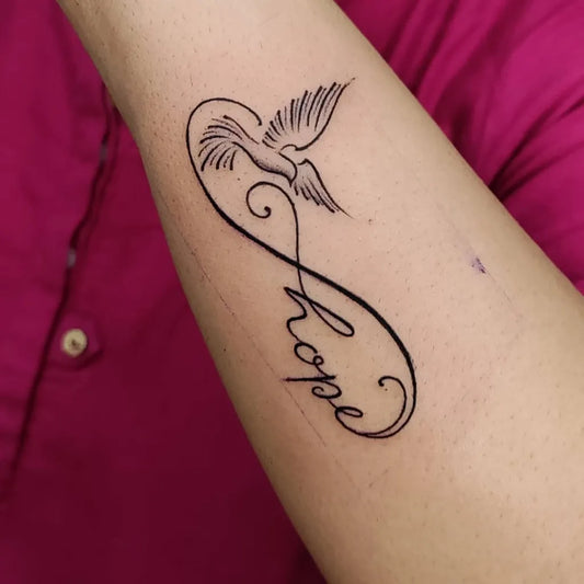 Small Fine Line Infinity Dove Hope Tattoo on Women Wrist by @7hillstattooz