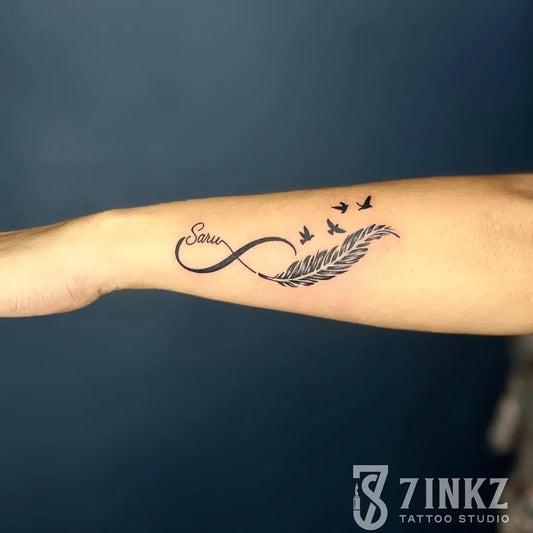 Small Fine Line Infinity Feather Birds Tattoo on Women Forearm by @7inkz_tattoo