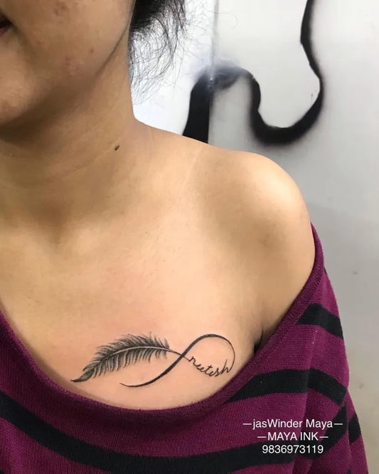 Small Fine Line Infinity Feathers Tattoo on Women Shoulder by @jaswindermaya