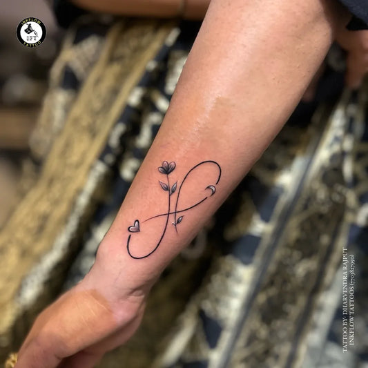 Small Fine Line Infinity Flower Heart Tattoo on Women Wrist by @tattoozbydharvendra