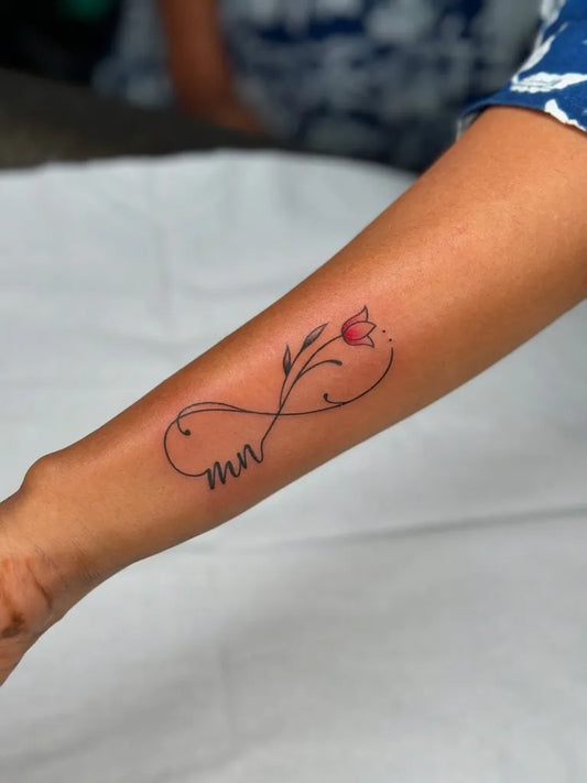 Small Fine Line Infinity Flower Name Tattoo on Women Arm by @the_tattoo_club_78