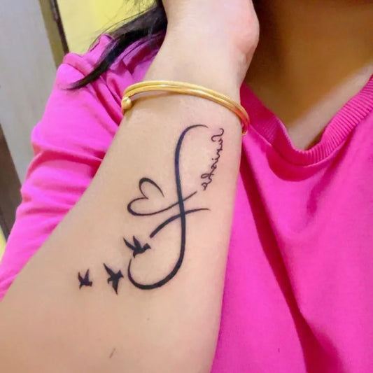 Small Fine Line Infinity Heart Birds Tattoo on Women Wrist by @influencer_nishazzz