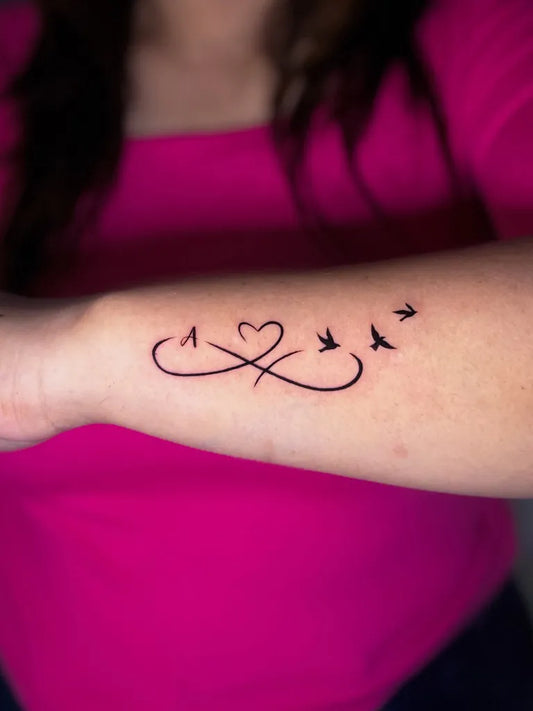 Small Fine Line Infinity Heart Birds Tattoo on Women Wrist by @tattoos.by.div