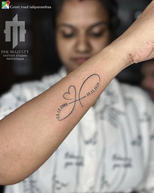 Small Fine Line Infinity Heart Dates Tattoo on Women Forearm by @tattoo_ink_majesty_taliparamba