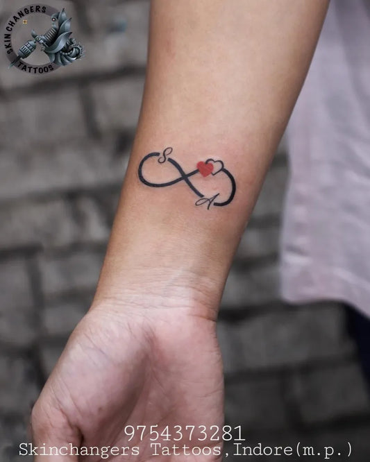 Small Fine Line Infinity Heart Tattoo on Women Forearm by @skinchangers_tattoos