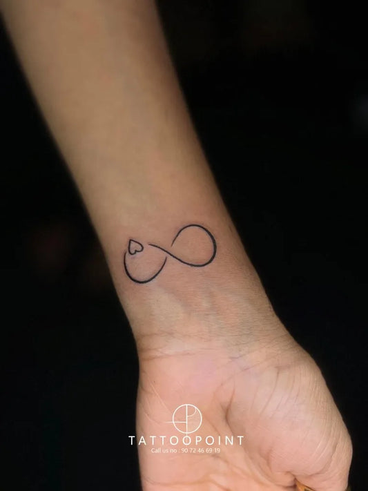 Small Fine Line Infinity Heart Tattoo on Women Wrist by @tattoo__point_ottapalam