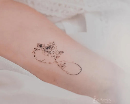Small Fine Line Infinity Rose Tattoo on Women Arm by @karolinaszymanska_tattoo