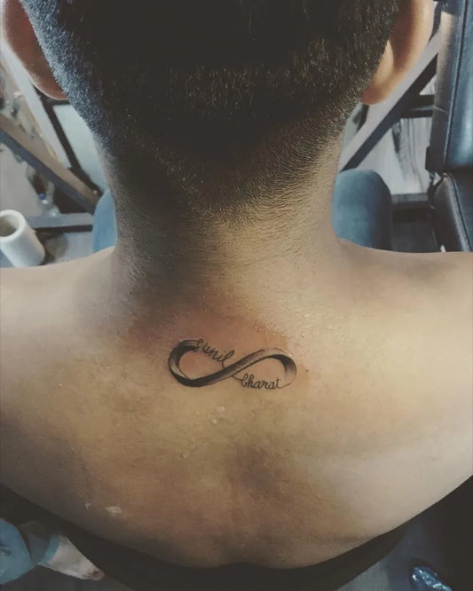 Small Fine Line Infinity Symbol with Text Tattoo on Women Nape by @naughtyneedlestattoos