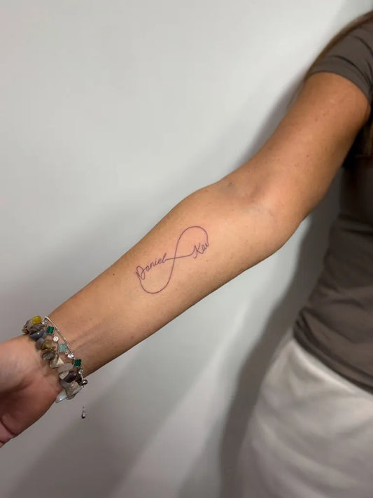 Small Fine Line Infinity Tattoo on Women Arm by @lucie.tattoo
