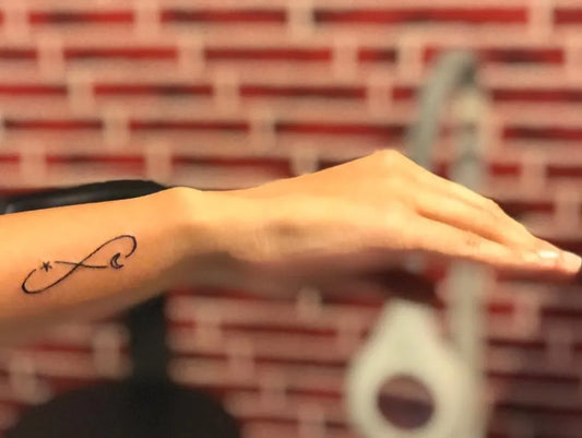 Small Fine Line Infinity Tattoo on Women Wrist by @darryl_fernandes_81