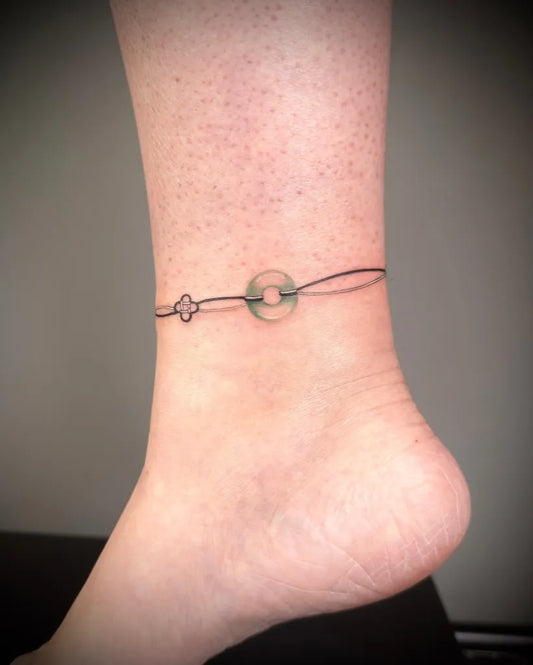 Small Fine Line Jade Anklet Wrap Tattoo on Women Ankle by @minaa.ink