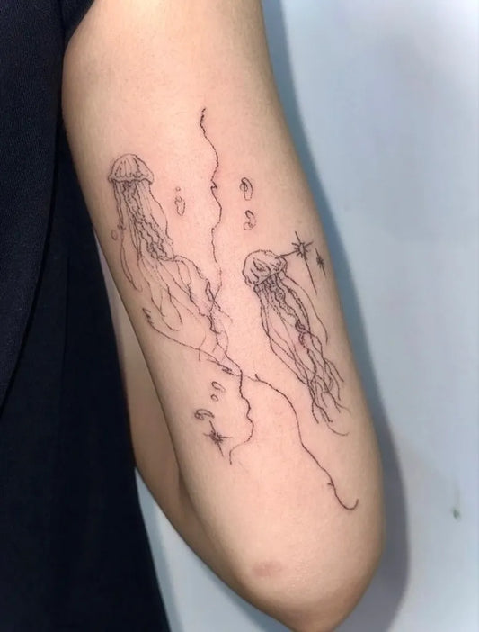 Small Fine Line Jellyfish Tattoo on Women Arm by @011poke